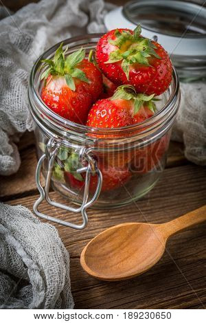 Strawberry In Jar On Wooden Background.