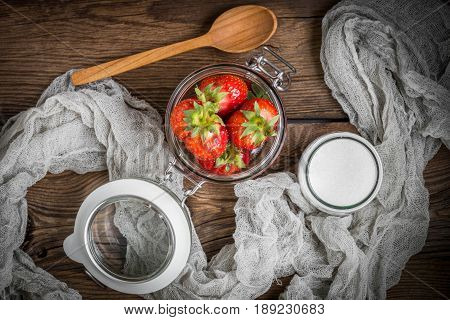 Strawberry In Jar On Wooden Background.