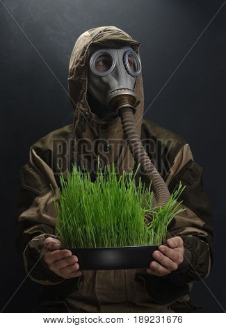 the photo of man in gas mask on grey background