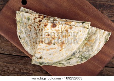Scallion pancakes. Round unleavened flatbread minced green onions. Top view.