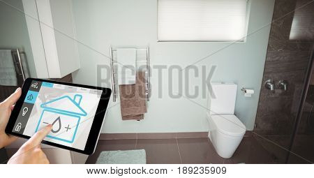 Digital composite of Hand using smart home application on digital tablet in washroom
