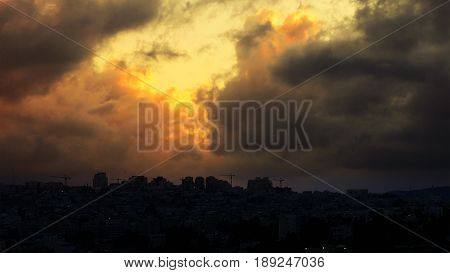 Sunset with huge cumuli clouds over the city. Jerusalem sunset at night dusk.