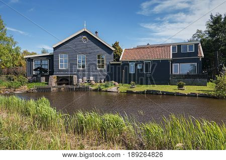 De Woude, Netherlands, April 30, 2017: Characteristic house iand also bucking n the village De Woude which is located on an island in the Alkmaarder and Uitgeester lake in The Netherlands