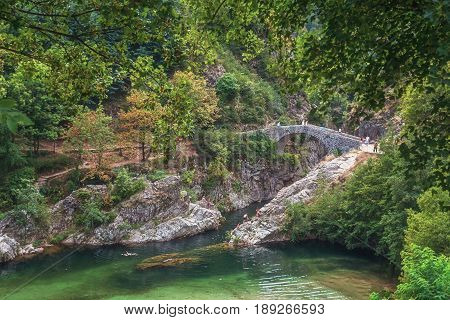 The Pont du Diable or Devil Bridge is a Roman bridge that spans the river Ardeche at about 10 m altitude. The bridge is located near the village of Thueyts in the Ardeche department in France