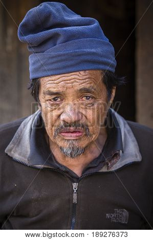HIMALAYAS ANNAPURNA REGION NEPAL - OCTOBER 16 2016 : Portrait old man in traditional dress in Himalayan village Nepal