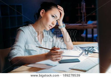 Young Tired Asian Businesswoman In White Blouse Working Till Late In Office