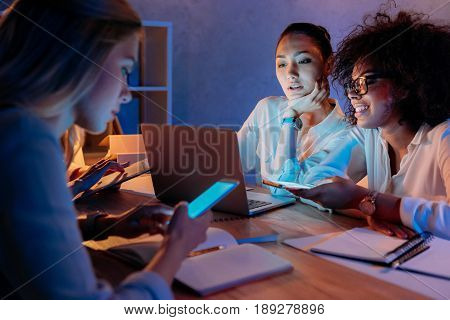 young multiethnic businesswomen working with digital devices at home office
