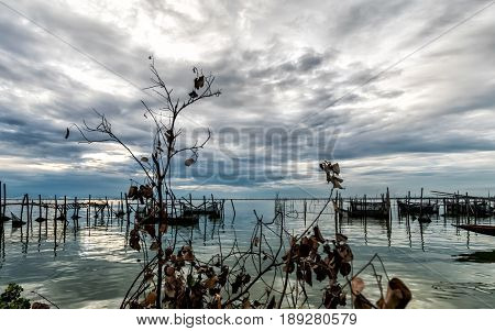 Homestay and floating basket in lake at Kohyo Songkhla Thailand with beautiful sky and clouds. This is traditional fisheries area.