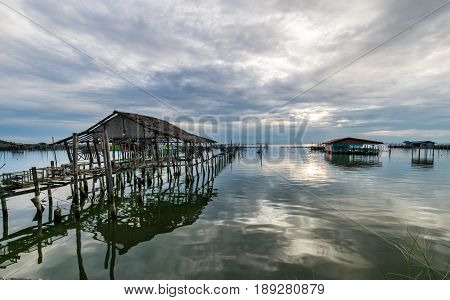 Homestay and floating basket in lake at Kohyo Songkhla Thailand with beautiful sky and clouds. This is traditional fisheries area.