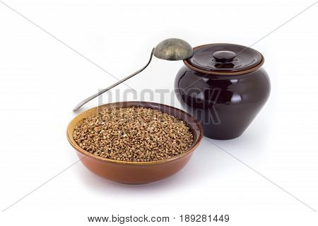 The Composition Of The Buckwheat Groats In A Clay Pial Next To A Clay Pot And A Copper Spoon,