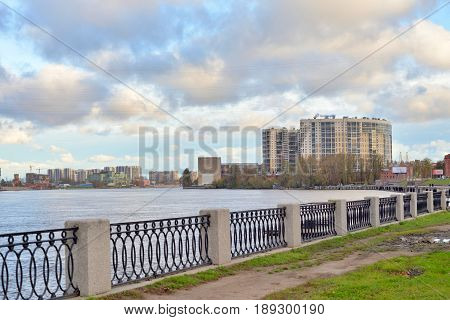 Embankment of the Obukhov defense of Neva River at cloud autumn day outskirts of Saint Petersburg Russia.