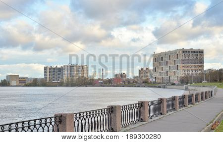 Embankment of the Obukhov defense of Neva River at cloud autumn day outskirts of Saint Petersburg Russia.