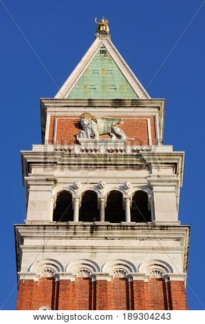 Campanile with an image of a lion on the Piazza San Marco or St Mark's Square in Venice Italy.