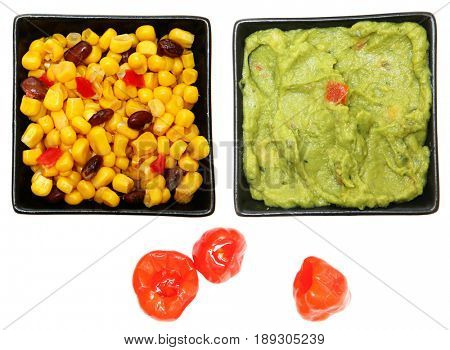 Bowl of Southwestern Corn, Guacamole and Peppadew Peppers over white.