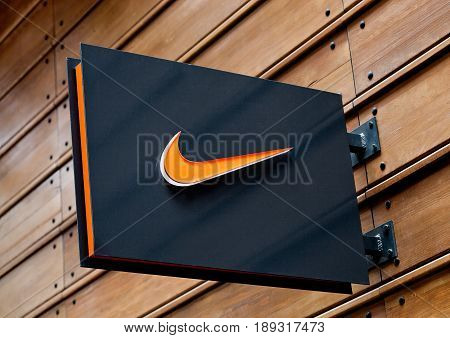London, Uk - June 02, 2017: Nike Logo On Black Display Plate On Wooden Background. Nike, Inc. Is An