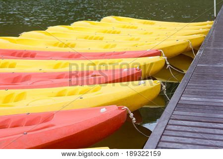 Group of red yellow color Kayak stop at the port