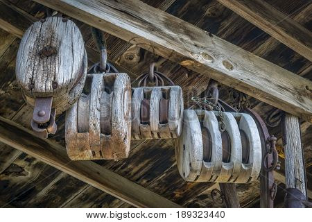 vintage wooden pulleys in an old barn or workshop
