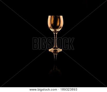 wine glass on table with reflection on black background