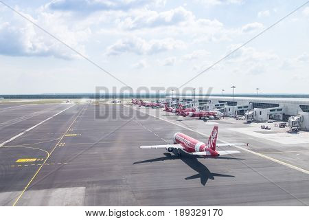 Kuala Lumpur, Malaysia - May 16, 2017: Many Airasia Plane And Clear Sky View From Terminal, Registra