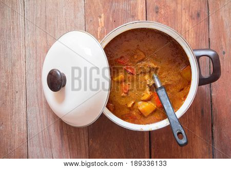 Beef Mussaman Curry In A Pot On Wood Background Top View