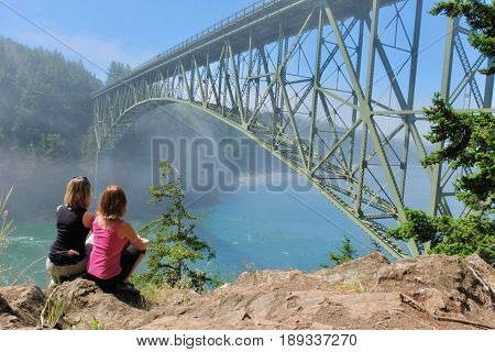 Group meditation by ocean in foggy morning. Deception Pass Bridge Park. Seattle. Anacortes. Washington. United States.