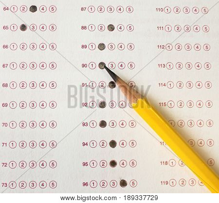 yellow pencil on exam answer sheet education test concept