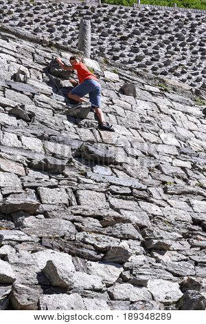 Boy Climbing On The Old Road