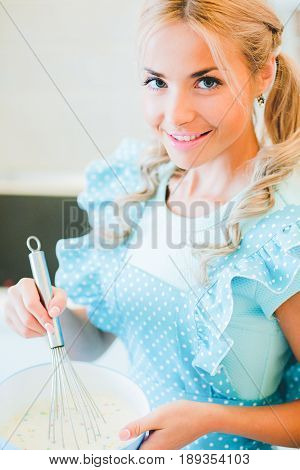 Smiling young housewife. Cooking baking in the kitchen at home