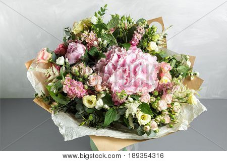 Still life with a bouquet of flowers. the florist put together a beautiful bunch of flowers. Man manual work used different types of flowers and colors.