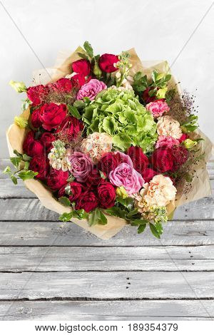 Still life with a bouquet of flowers. the florist put together a beautiful bunch of flowers. Man manual work used different types of flowers and colors.