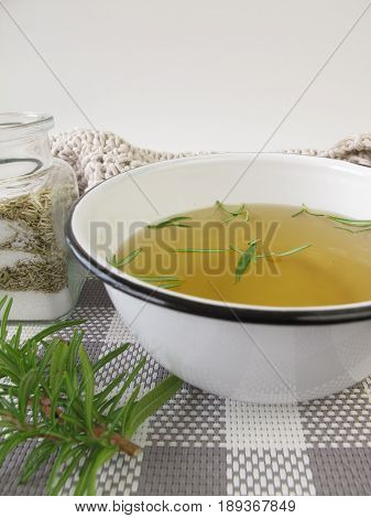 Footbath with rosemary bath salt in bowl