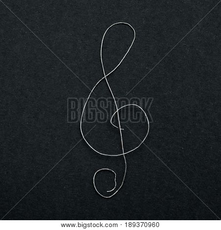Musical Sign Clef On Black Paper
