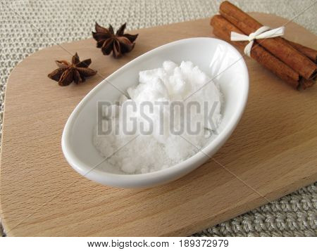 Bakers ammonia in bowl and spices on wooden board