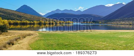 Panoramic image of beautiful scenery of Lake Pearson (Moana Rua) in Autumn Arthur's pass National Park South Island of New Zealand