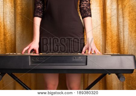 Unrecognizible Girl Musician Playing On Electronic Piano