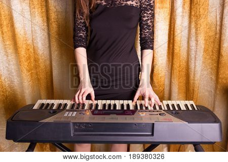 Unrecognizible Girl Musician Playing On Electronic Piano