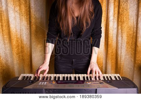 Unrecognizible Girl Musician Playing On Electronic Piano