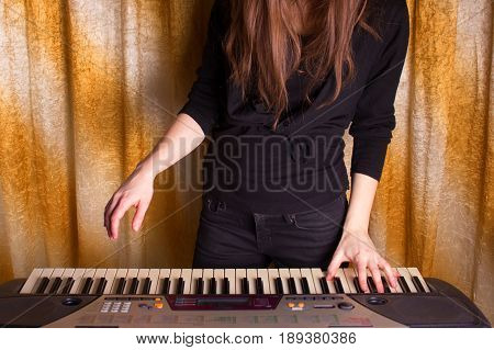Unrecognizible Girl Musician Playing On Electronic Piano