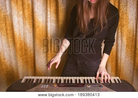 Unrecognizible Girl Musician Playing On Electronic Piano