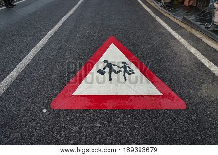 School Sign children student crossing sign on the street after raining.