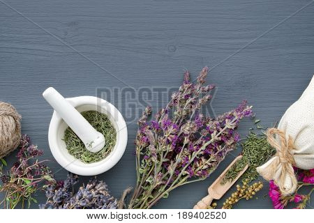 Bunches Of Healing Herbs, Mortar And Sachet On Board. Herbal Medicine. Top View, Flat Lay.