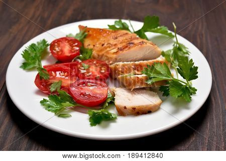 Dinner with sliced roasted chicken breast and vegetable salad. Shallow depth of field