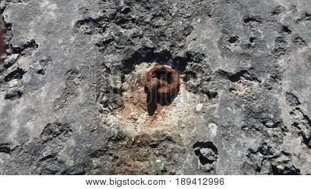 rusty old chain rings on the stone