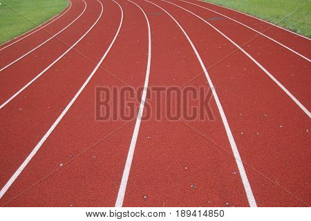 Eight lane track and field that is coming up on a curve