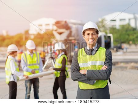 Asian businessmanAsian secretary and Asian construction engineer checking construction site for new Infrastructure construction project