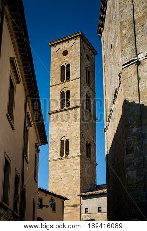 Volterra, Tuscany - May 21, 2017 - Baptistery Of San Giovanni Battista And Tower Of Cathedral