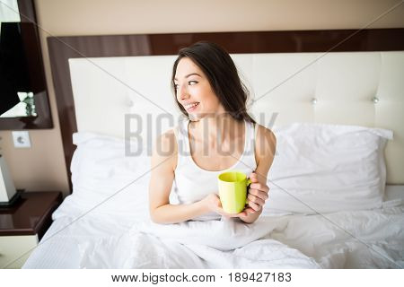 Beautiful Girl At Her Bedroom Drinking Tea In The Morning.