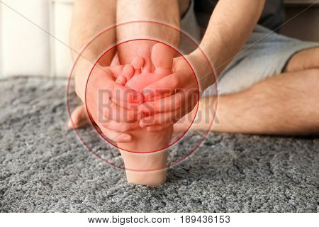 Health care concept. Man suffering from pain in feet, closeup