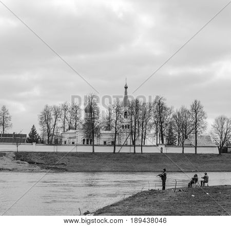 Belarus Orsha - April 11 2017: Three fishermen on the river bank. Black and white processing