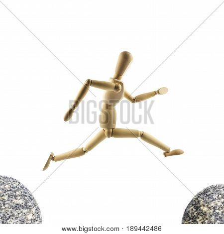 Wooden mannequin is jumping over the abyss isolated on white background. Big jump concept.